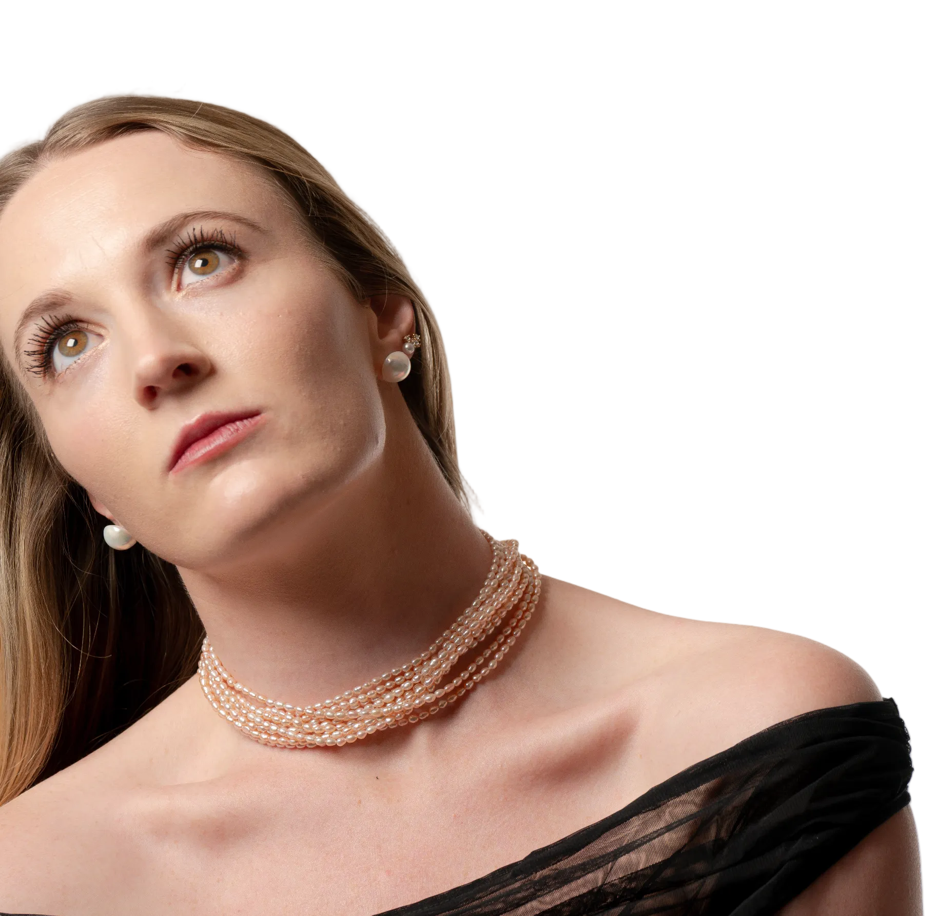Woman wearing a pearl necklace against a plain background
